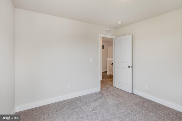 empty room featuring light carpet