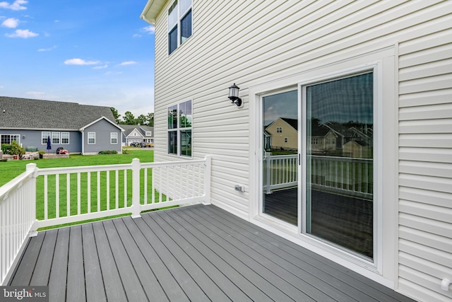 wooden deck with a lawn