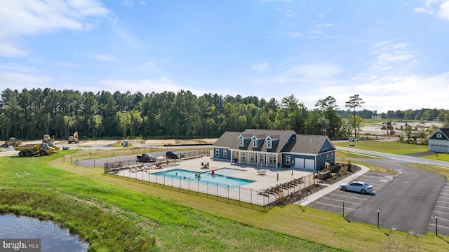 view of swimming pool featuring a yard and a patio