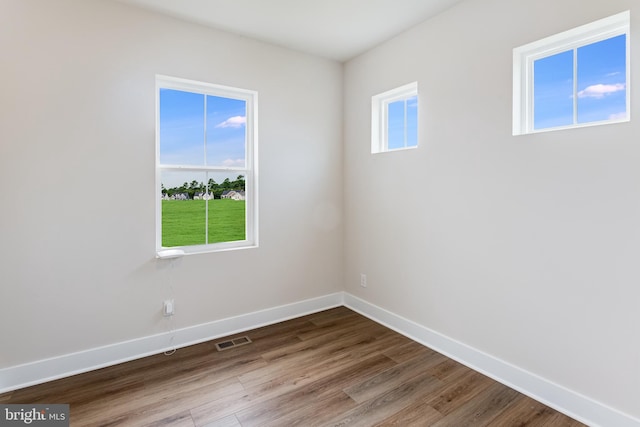 unfurnished room featuring hardwood / wood-style flooring