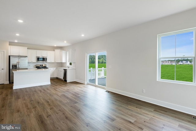 unfurnished living room with wood-type flooring