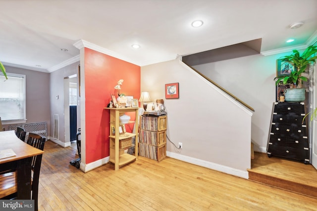 interior space featuring ornamental molding and hardwood / wood-style flooring