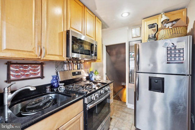 kitchen with sink, light tile patterned flooring, stainless steel appliances, and light brown cabinets