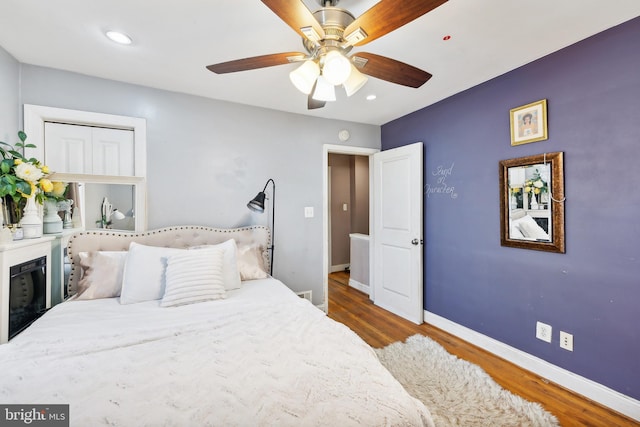 bedroom with ceiling fan and hardwood / wood-style floors