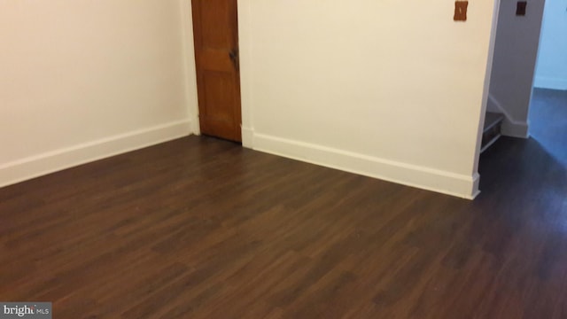 unfurnished room with dark hardwood / wood-style floors