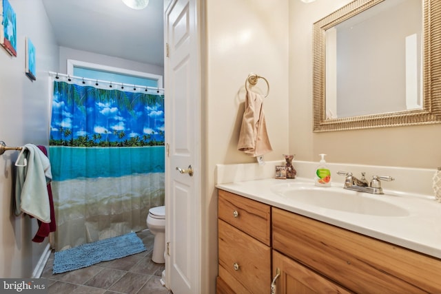 bathroom featuring tile patterned flooring, vanity, toilet, and curtained shower