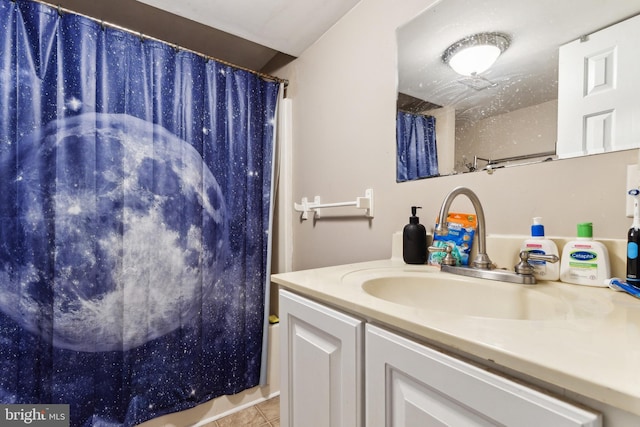 bathroom with tile patterned flooring, vanity, and shower / tub combo with curtain