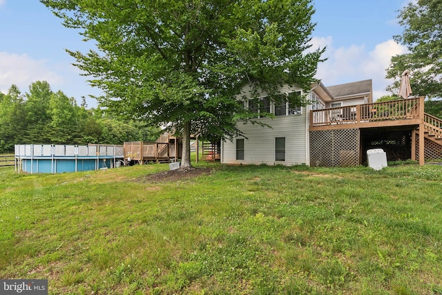 view of yard with a pool side deck