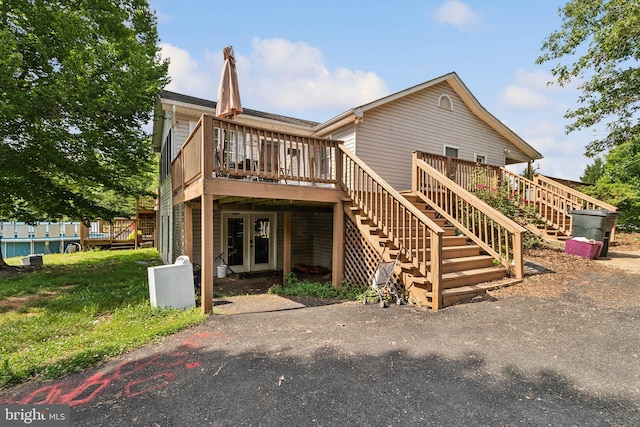 rear view of house with french doors and a deck