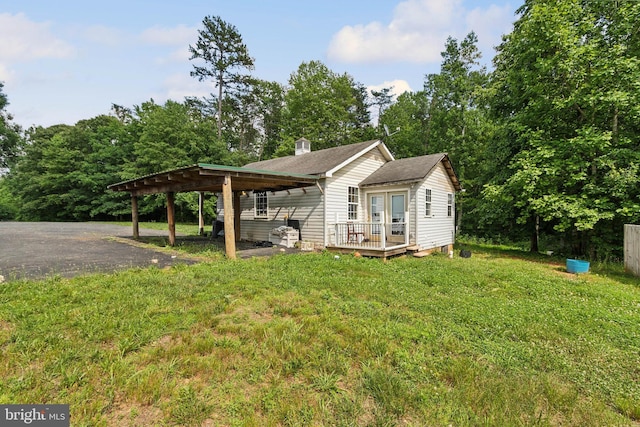 exterior space with a deck and a lawn