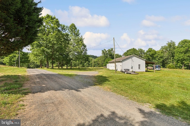 exterior space featuring a front yard and a carport