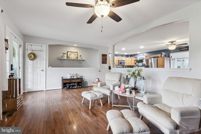 living room with ceiling fan and wood-type flooring