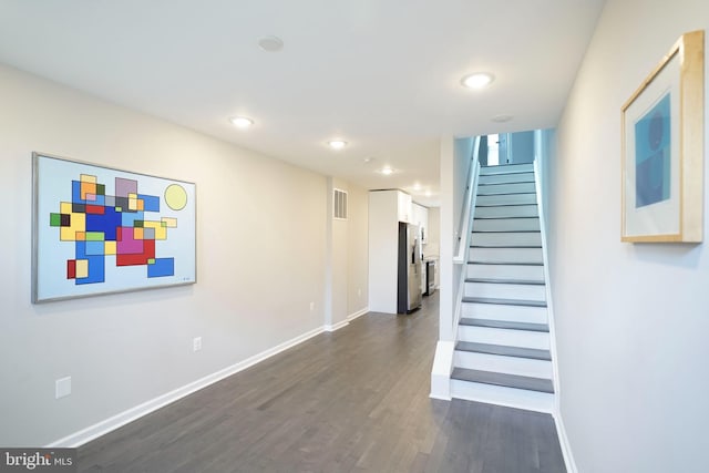 stairway featuring wood-type flooring