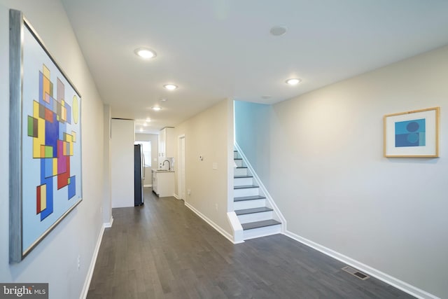 hallway with dark hardwood / wood-style floors