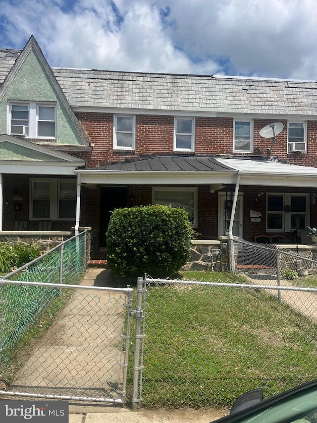 view of front facade with cooling unit and a front lawn