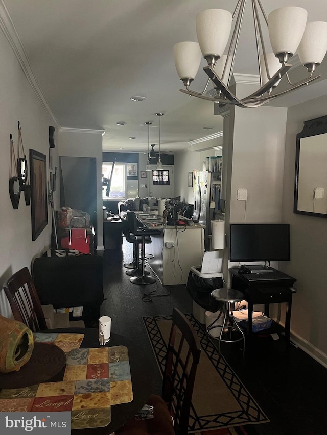 living room featuring a chandelier, wood-type flooring, and ornamental molding