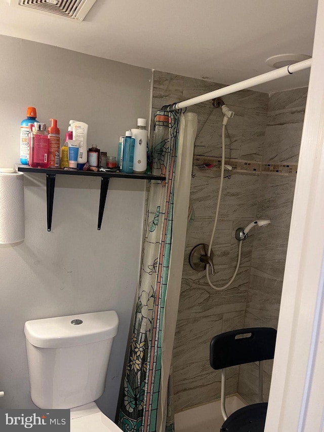 bathroom with toilet and walk in shower