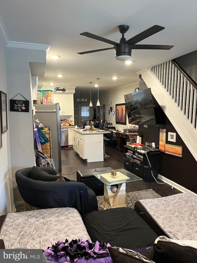 living room with ceiling fan and ornamental molding