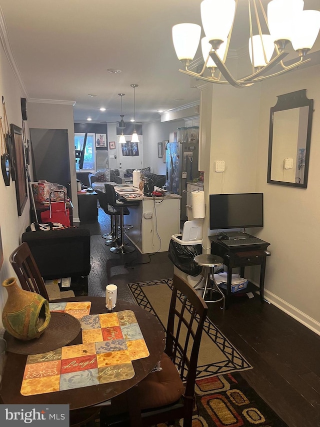 dining area featuring crown molding, dark hardwood / wood-style floors, and a notable chandelier