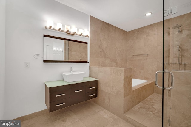 bathroom featuring tile patterned floors, a shower with door, and vanity