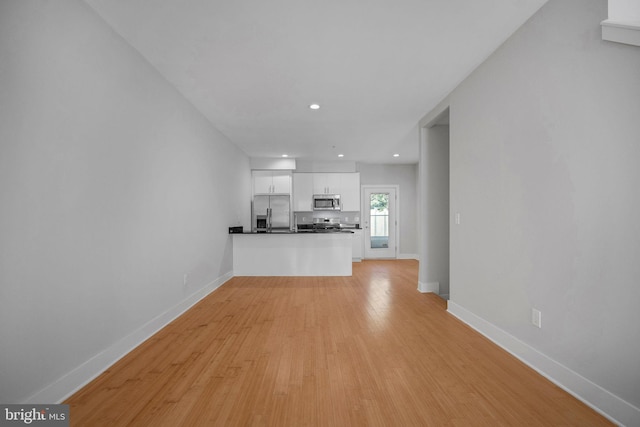 unfurnished living room featuring light hardwood / wood-style floors