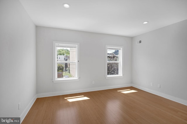 unfurnished room featuring hardwood / wood-style flooring