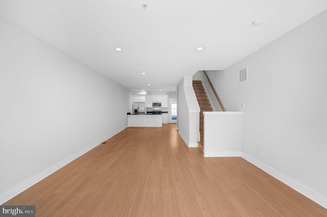 unfurnished living room featuring light wood-type flooring