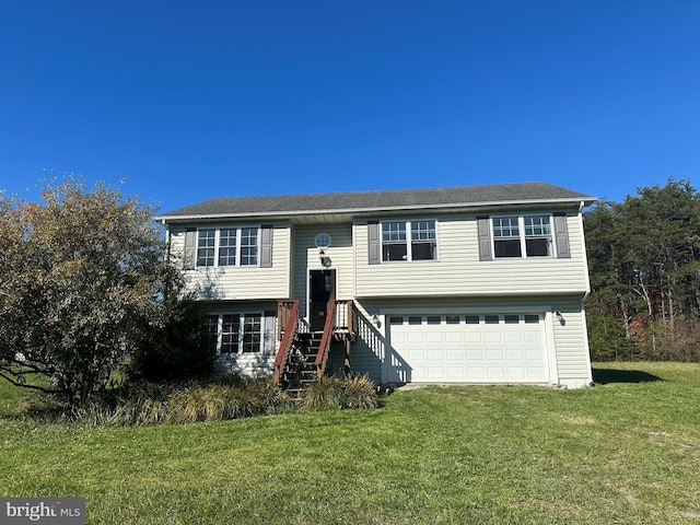 split foyer home with a garage and a front lawn