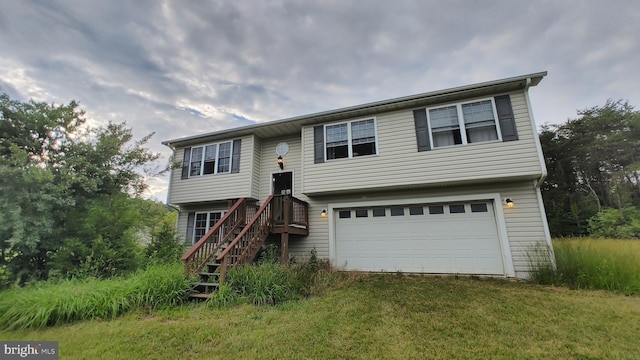 bi-level home featuring a front yard and a garage