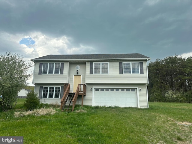 bi-level home with a garage and a front lawn