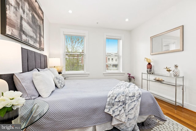 bedroom with hardwood / wood-style flooring and ensuite bath