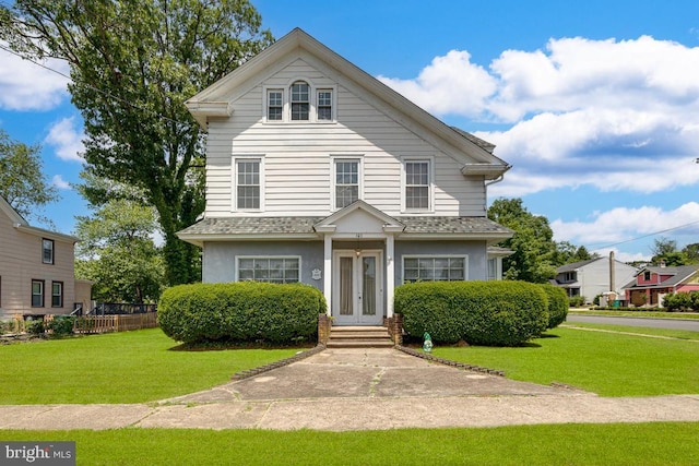 view of front facade with french doors and a front yard