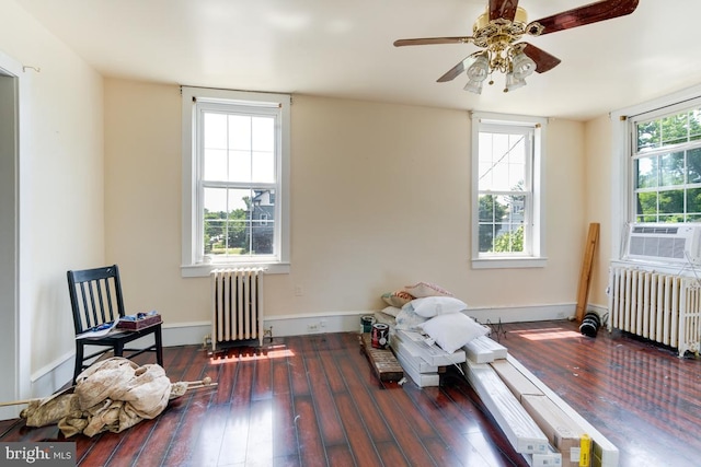 misc room with radiator heating unit, dark hardwood / wood-style floors, ceiling fan, and cooling unit