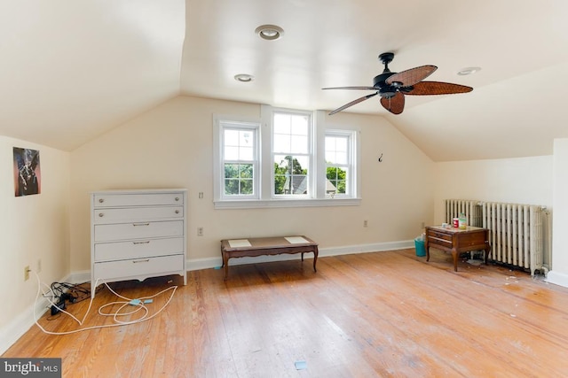 additional living space featuring radiator, ceiling fan, hardwood / wood-style floors, and vaulted ceiling