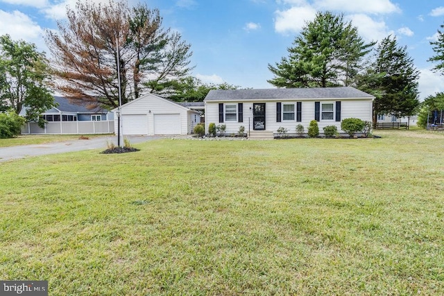 ranch-style home with a garage and a front lawn