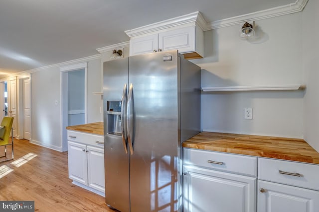 kitchen featuring white cabinetry, stainless steel fridge with ice dispenser, and wooden counters