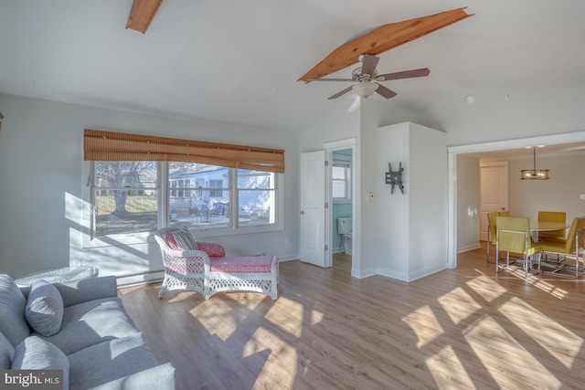 living room featuring ceiling fan, lofted ceiling with beams, and light hardwood / wood-style floors