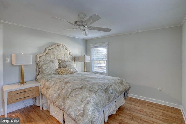 bedroom featuring ceiling fan, light hardwood / wood-style floors, and ornamental molding