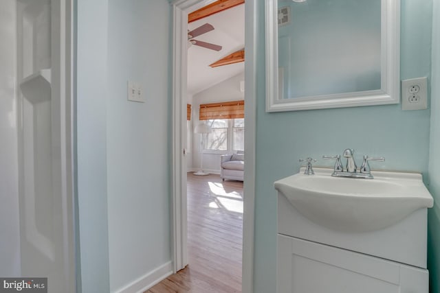 bathroom featuring hardwood / wood-style floors, vanity, and lofted ceiling