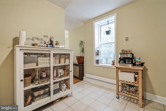 interior space featuring baseboard heating and light tile patterned floors