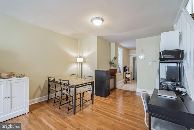 dining space with light hardwood / wood-style flooring