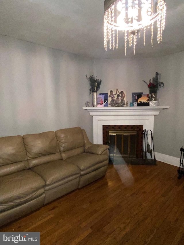 living room featuring wood-type flooring and a chandelier