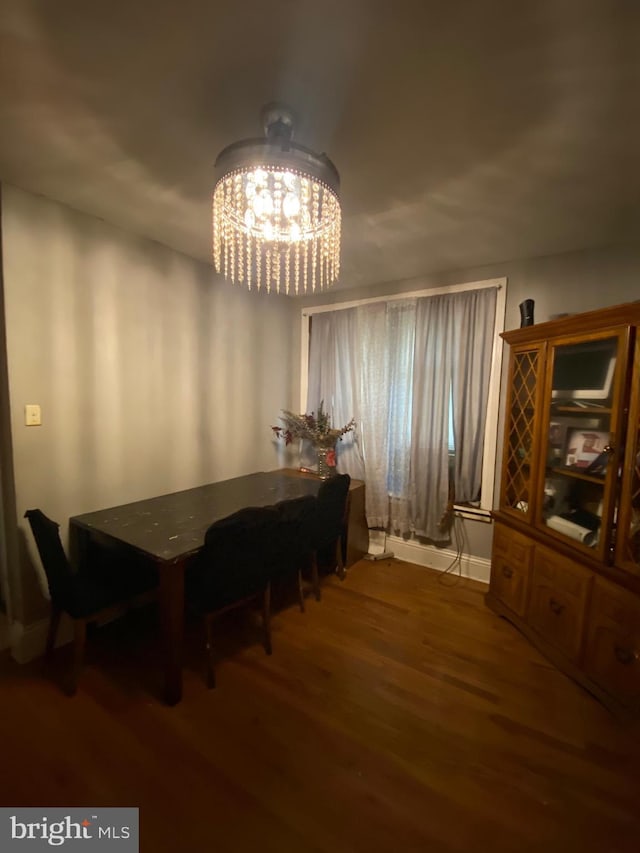 dining area with a chandelier and wood-type flooring