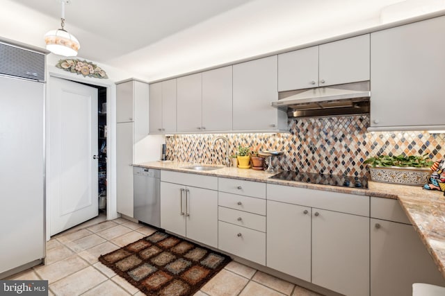 kitchen with sink, hanging light fixtures, decorative backsplash, light tile patterned floors, and stainless steel appliances