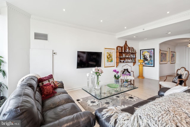 living room featuring light hardwood / wood-style floors and crown molding