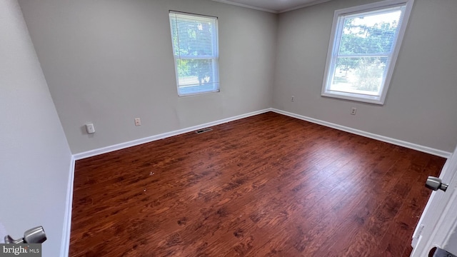 unfurnished room with dark hardwood / wood-style floors and crown molding