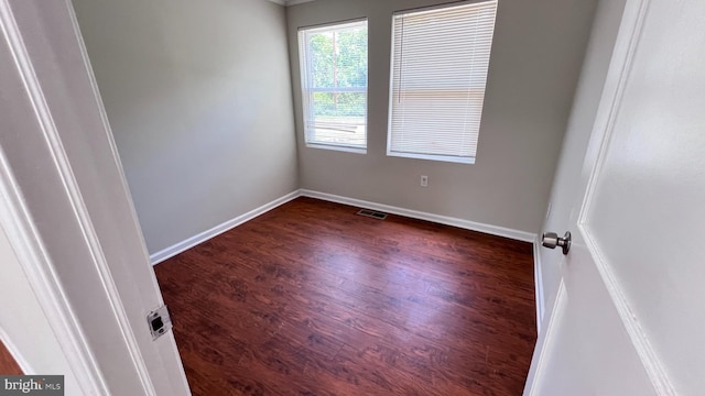 empty room with dark wood-type flooring