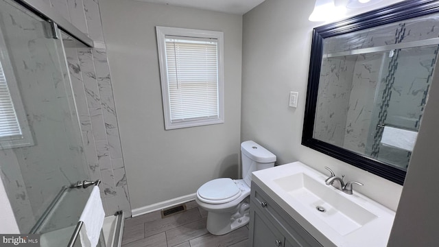 bathroom with wood-type flooring, vanity, toilet, and an enclosed shower