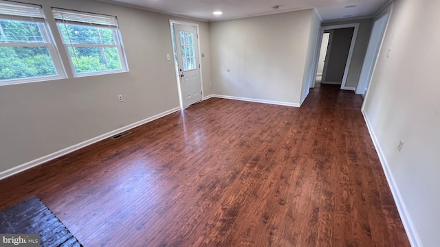 foyer featuring dark hardwood / wood-style flooring and crown molding