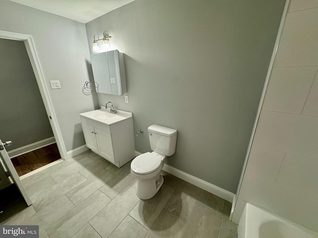 bathroom with hardwood / wood-style floors, vanity, and toilet